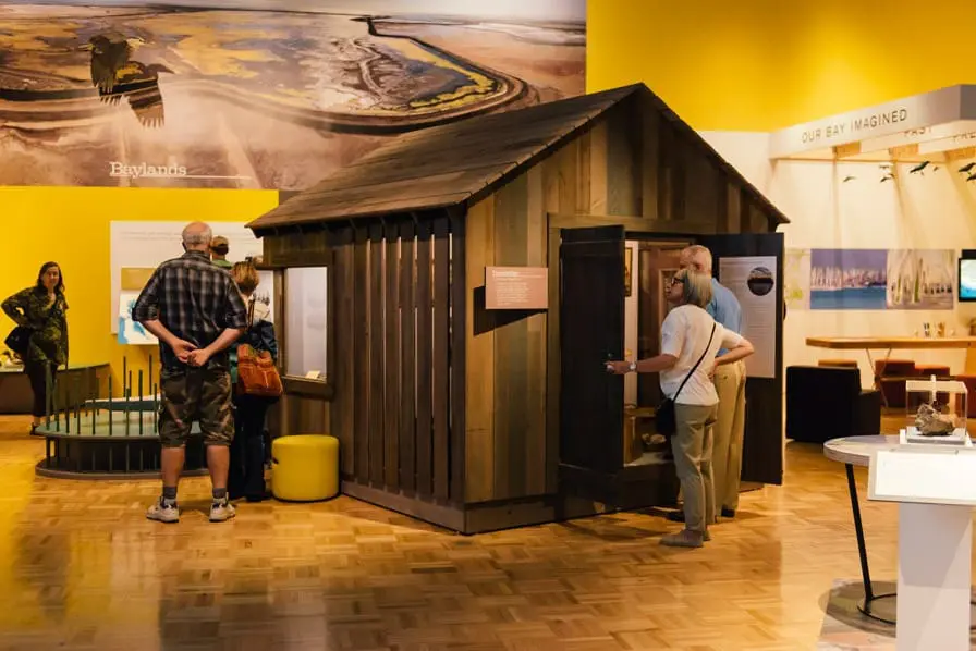 In the 'Baylands' section of the Gallery, visitors can view a number of artifacts from the town of Drawbridge, a now defunct duck-hunting settlement on the shores of the South Bay, in an interactive 'hunting shack'. People came from all over during the turn of the 20th century to exploit the natural resources of this area, which was later abandoned and today is one of the only ghost towns in the Bay Area. Photo: Shaun Roberts. Courtesy of Oakland Museum of California.