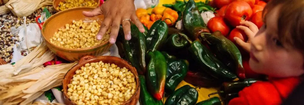 Corn and peppers being prepared for Dia de Muertos at OMCA