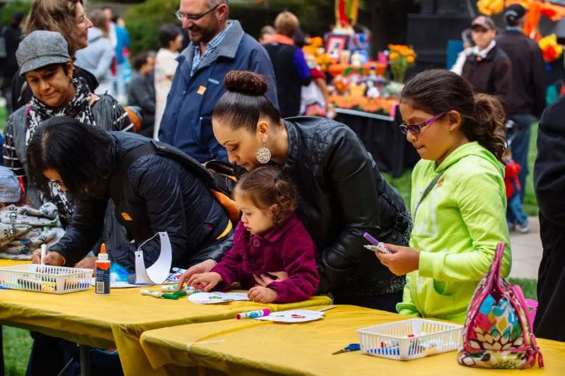 Adults and children doing crafts at OMCA