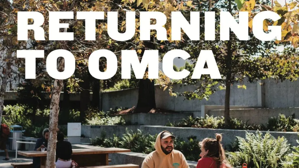 Returning to OMCA - image of two people eating at a picnic table Returning to OMCA - image of two people eating at a picnic table