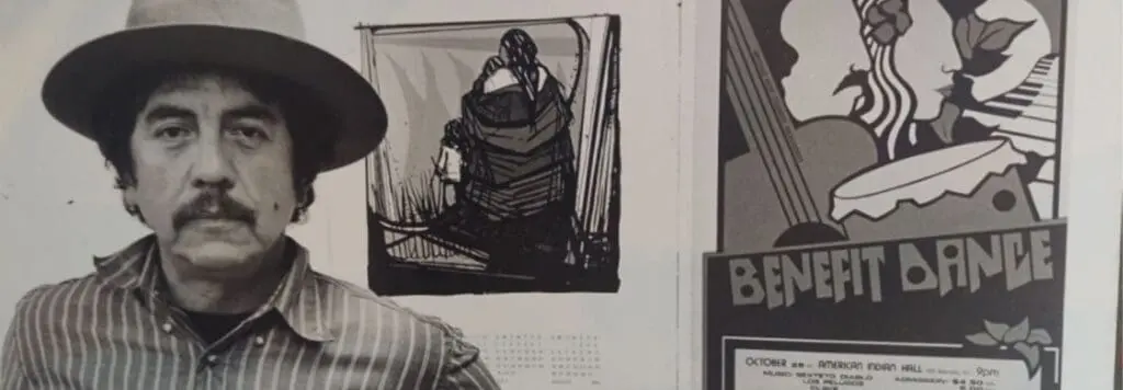 Malaquis Montoya in black and white next to some art