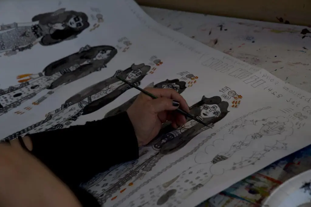 Artists hand painting a person with long hair 