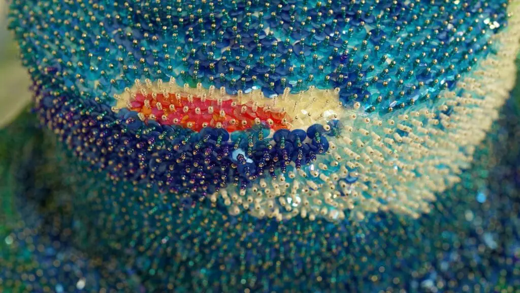 sculpture with blue, white, and red beading