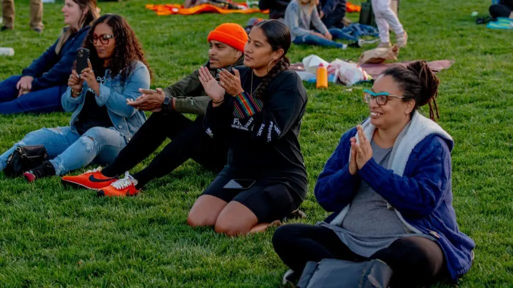 People sitting on the grass lawn at OMCA