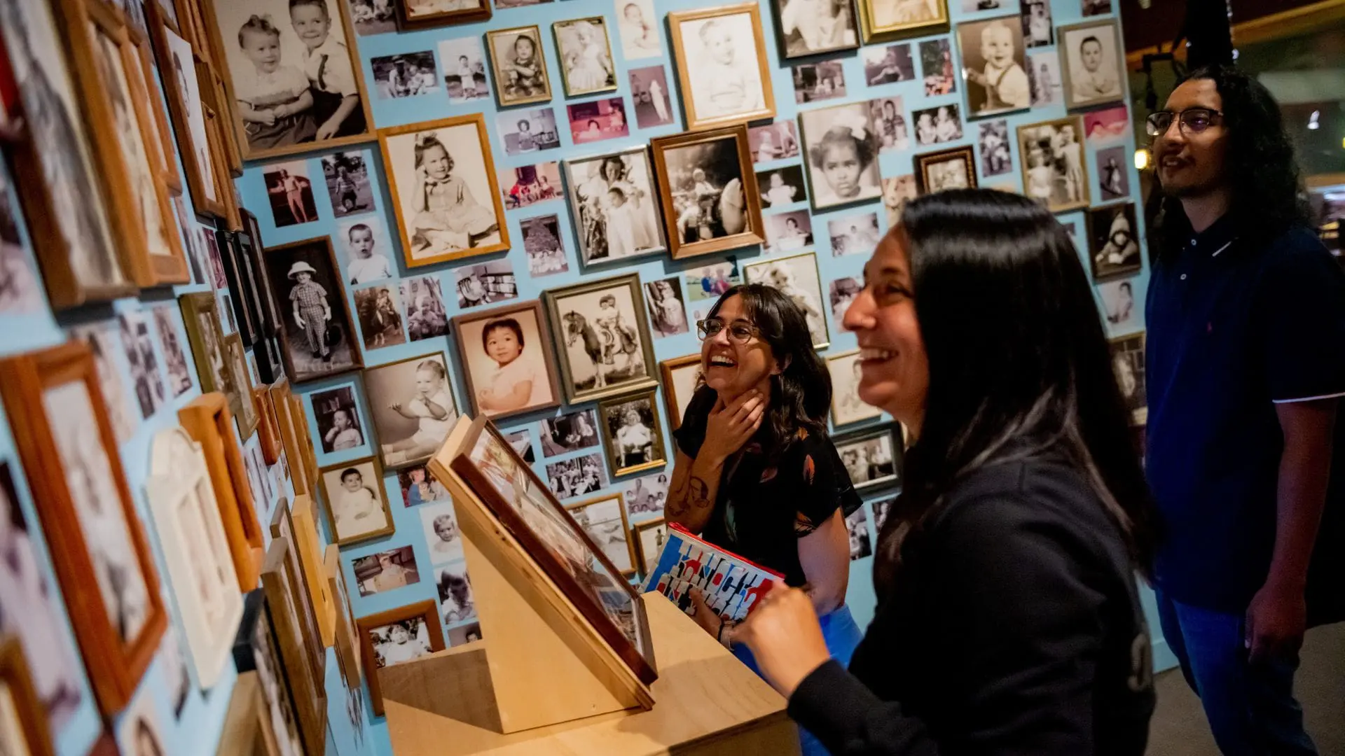 Two women laughing in OMCA's Gallery of CA History