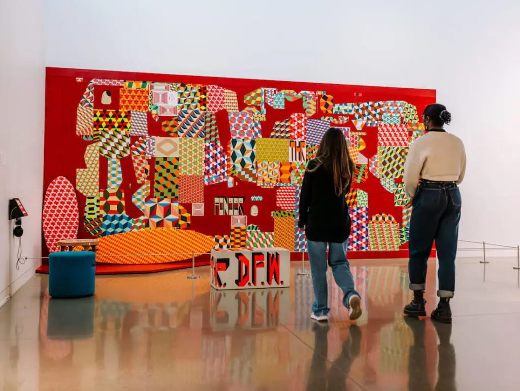 Museum visitors gazing at large painting