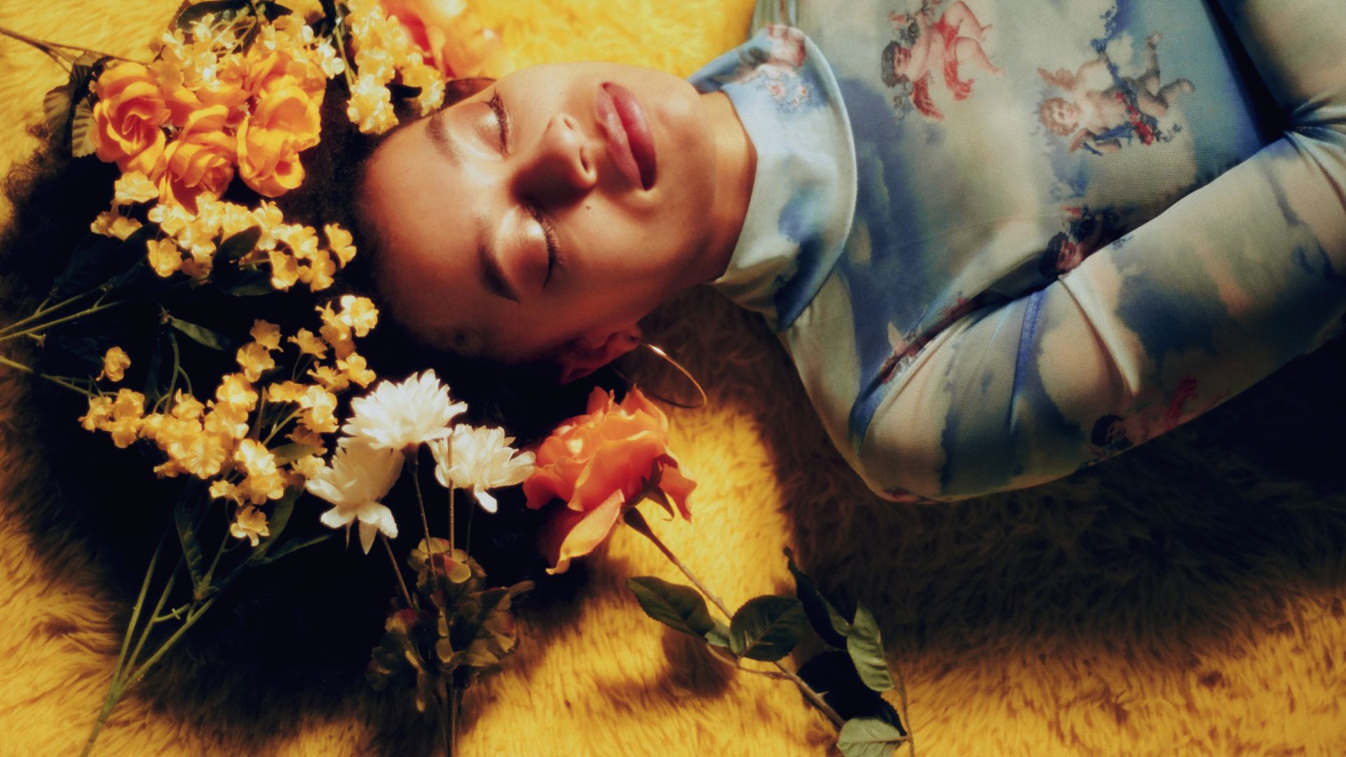 August Lee Stevens lying down with flowers in her hair