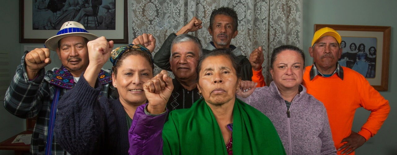 group from teatro jornalero standing together with raised fists. Credit: Carla Hernandez Ramirez